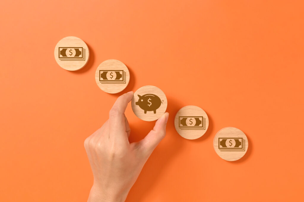 Wooden block with money banknote and piggy bank, Interest rate increases, Profit from deposit money, Successful business investment, Money savings for future, Interest rate and mortgage rates