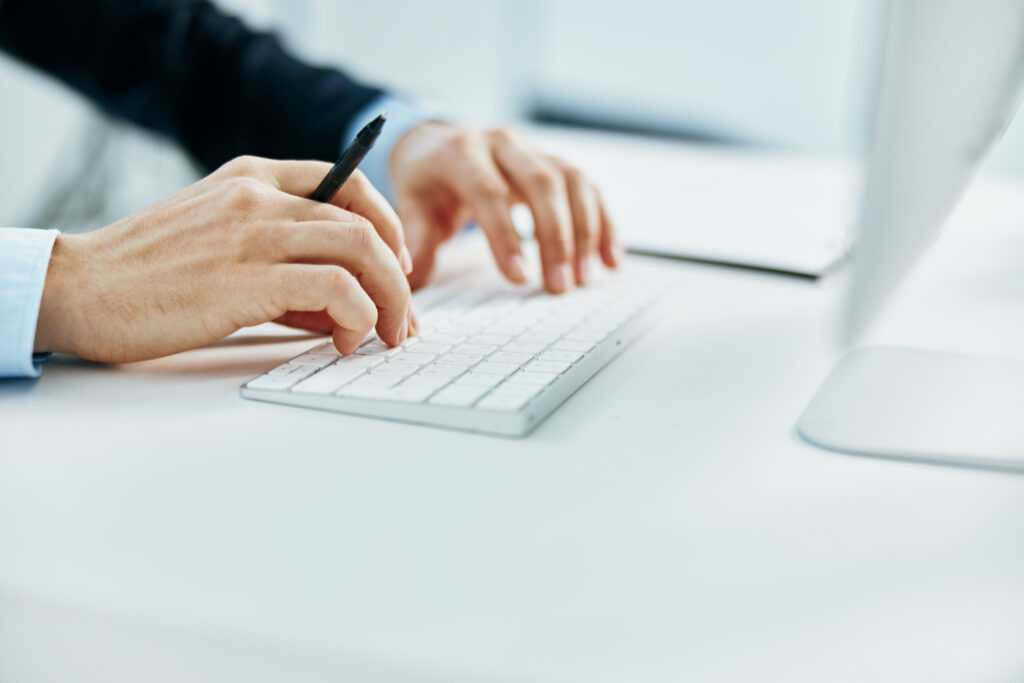 hands typing on keyboard